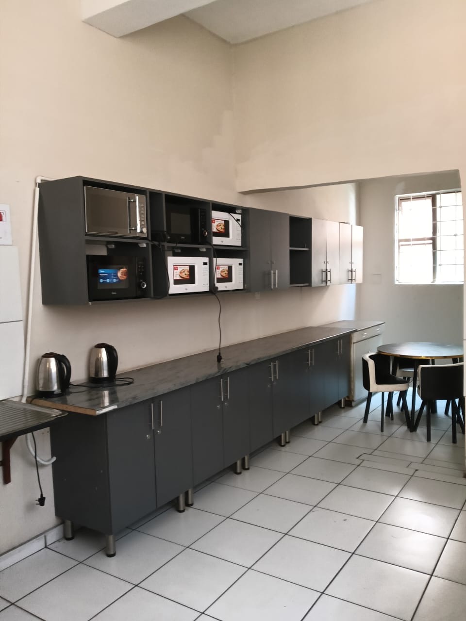 Shared kitchen with microwaves and dining area